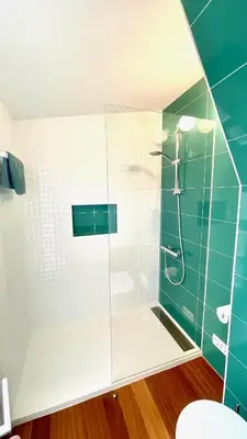 a bathroom with a glass shower with a toilet at The Cliffs - MarCastelos in Viveiro