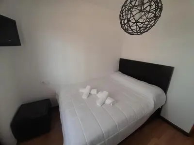 a white bed with two pillows on it in a room at EnViveiro a pie de Playa de Covas II in Viveiro