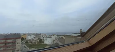 a view of a city from a window at EnBURELA Tus Mejores Vacaciones in Burela de Cabo