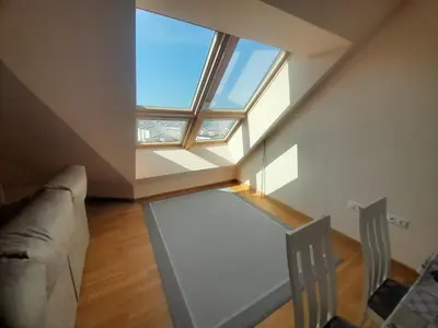 a living room with a couch and a large window at EnBURELA Tus Mejores Vacaciones in Burela de Cabo