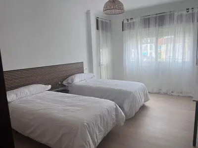 a hotel room with two beds and a window at Dimar in Quiroga