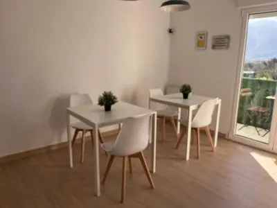 a dining room with two tables and white chairs at Dimar in Quiroga