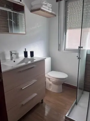 a bathroom with a toilet and a sink and a shower at Dimar in Quiroga