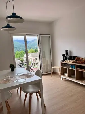 a living room with a table and chairs with a view at Dimar in Quiroga