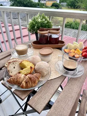 a table with a plate of bread and fruit on it at Dimar in Quiroga