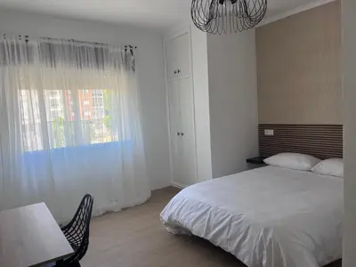 a bedroom with a bed and a table and a window at Dimar in Quiroga