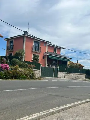 a pink house on the side of a street at Casa As Bateas in Sada