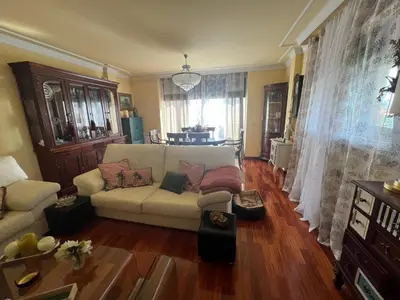 a living room with a white couch and wooden floors at Casa As Bateas in Sada