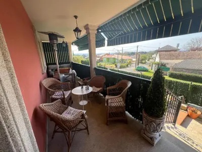 a balcony with a table and chairs and a view at Casa As Bateas in Sada