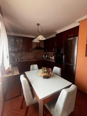 a kitchen with a white table and chairs and a kitchen with at Casa As Bateas in Sada