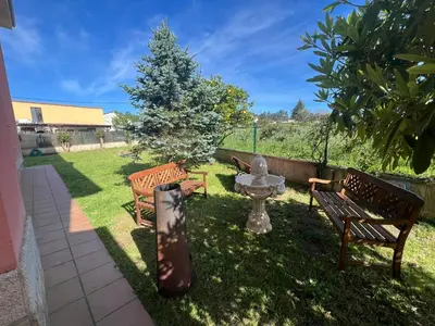 a group of benches in a yard with a tree at Casa As Bateas in Sada