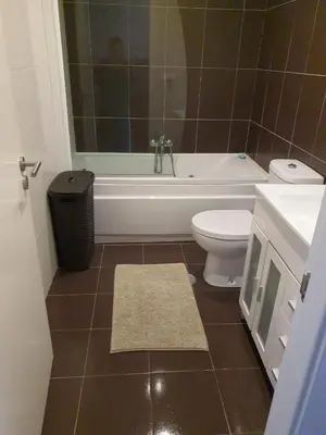a bathroom with a tub and a toilet and a sink at Apartamento en Playa de Altar in San Cosme de Barreiros