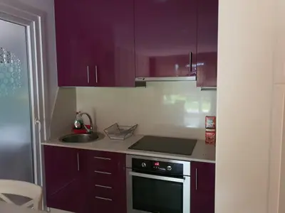 a kitchen with purple cabinets and a stove at Apartamento en Playa de Altar in San Cosme de Barreiros