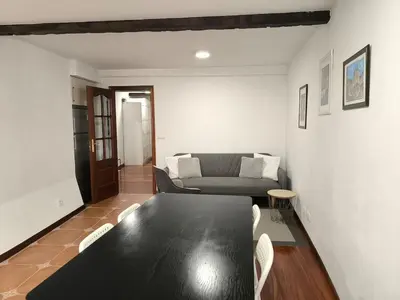 a living room with a black table and a couch at A 100 metros Catedral, 3º -Galería -Duplex in Santiago de Compostela