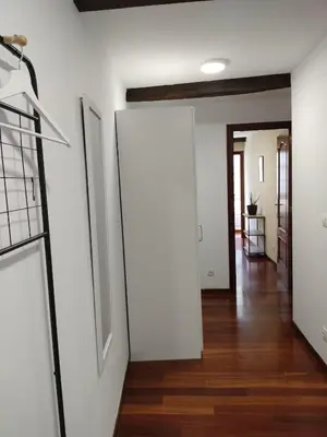 an open hallway with white walls and wood floors at A 100 metros Catedral, 3º -Galería -Duplex in Santiago de Compostela