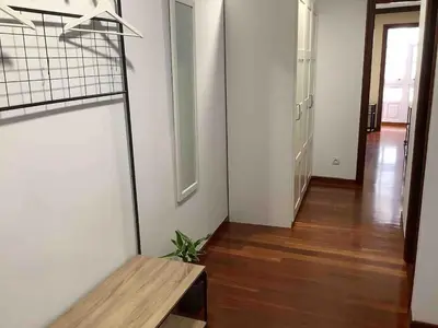 a room with a wooden bench and a hallway at A 100 metros Catedral, 3º -Galería -Duplex in Santiago de Compostela