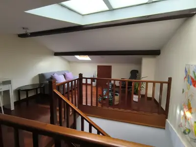 a living room with a staircase with a skylight at A 100 metros Catedral, 3º -Galería -Duplex in Santiago de Compostela