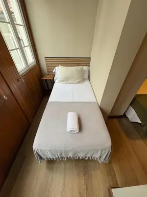 a small room with two beds in a attic at Hotel Real in Santiago de Compostela