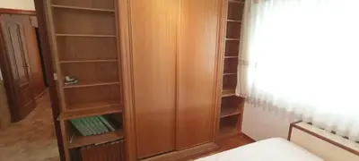 a closet with a wooden cabinet in a room at EnVIVEIRO Destino Playa de Covas in Viveiro