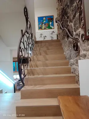 a staircase in a house with a stone wall at Casa Desigual in Padrón