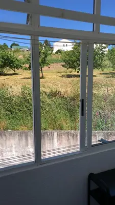 a window in a room with a view of a field at Casa Vimar in Portomarin