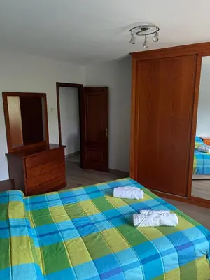 a bedroom with a bed with two towels on it at Casa Vimar in Portomarin