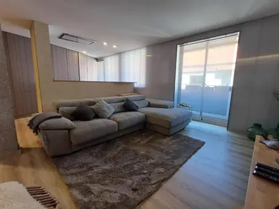 a living room with a couch and a large window at Villa Mayfa - alójate en pleno centro de Ourense in Ourense