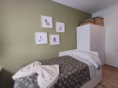 a bedroom with a bed and pictures on the wall at Villa Mayfa - alójate en pleno centro de Ourense in Ourense
