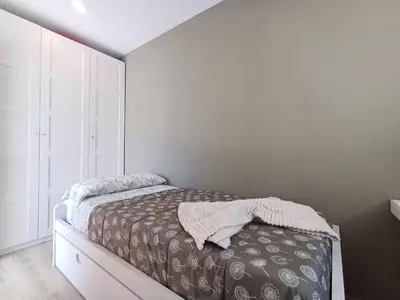 a bedroom with a bed and a dresser at Villa Mayfa - alójate en pleno centro de Ourense in Ourense