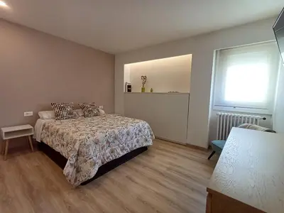 a bedroom with a bed and a window at Villa Mayfa - alójate en pleno centro de Ourense in Ourense
