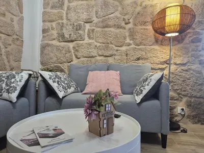 a living room with a blue couch and a table at Casa Carradas in Villarino Frío