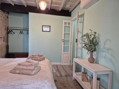 a bedroom with a bed and a table with towels on it at Casa Carradas in Villarino Frío