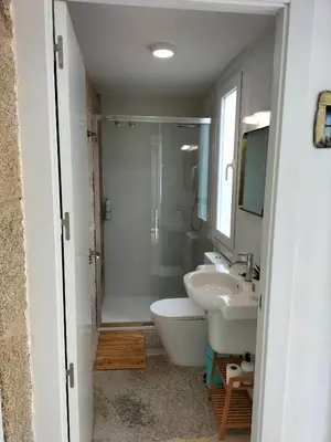 a bathroom with a toilet and a sink and a shower at Casa Carradas in Villarino Frío