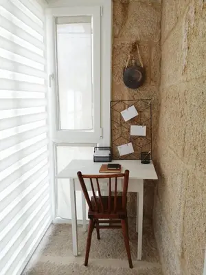 a white desk with a chair and a window at Casa Carradas in Villarino Frío