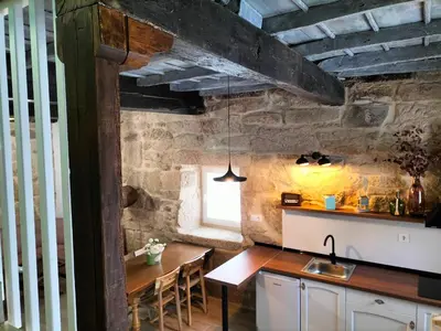 a kitchen with a table and a dining room at Casa Carradas in Villarino Frío