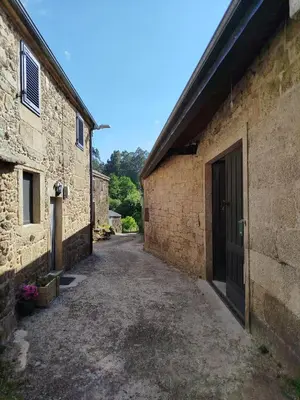 an alley between two stone buildings with a door at Casa Gallufe in Santiago de Compostela
