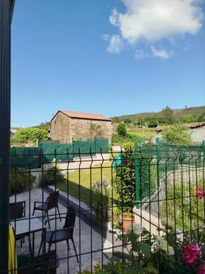 a view of a patio with chairs and a fence at Casa Gallufe in Santiago de Compostela