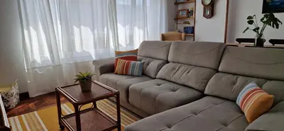 a living room with a couch and a table at Apartamento Piñeirua in Ribadeo