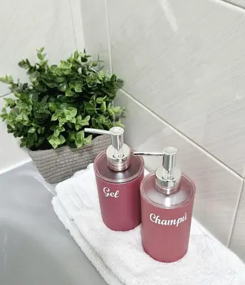 two red containers sitting on a towel in a bathroom at Apartamento Piñeirua in Ribadeo