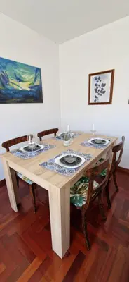a wooden table with four chairs around it at Apartamento Piñeirua in Ribadeo