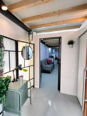 a living room with a couch and a mirror at VilafraggleRock, casa de diseño moderno en Pontedeume in Puentedeume