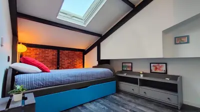 a bedroom with a large bed and a window at VilafraggleRock, casa de diseño moderno en Pontedeume in Puentedeume