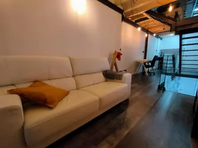 a living room with a white couch and a table at VilafraggleRock, casa de diseño moderno en Pontedeume in Puentedeume