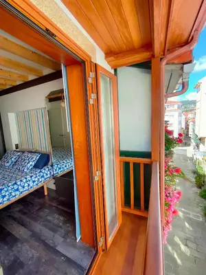 a balcony of a house with a bed and a window at VilafraggleRock, casa de diseño moderno en Pontedeume in Puentedeume