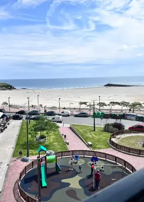 a view of a playground next to the beach at Apartamentos Terraza playa II in Foz