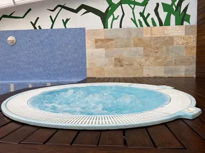 a hot tub sitting on a wooden deck at Apartamentos Terraza playa II in Foz
