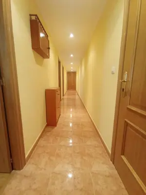 an empty hallway with a door and a long corridor at Apartamentos Terraza playa II in Foz