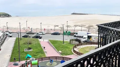 a balcony with a view of a parking lot and the beach at Apartamentos Terraza playa II in Foz