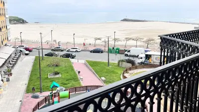 a balcony with a view of a parking lot and the beach at Apartamentos Terraza playa II in Foz