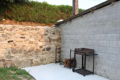 a wooden table next to a brick wall at CASA PEINADO in Boimorto